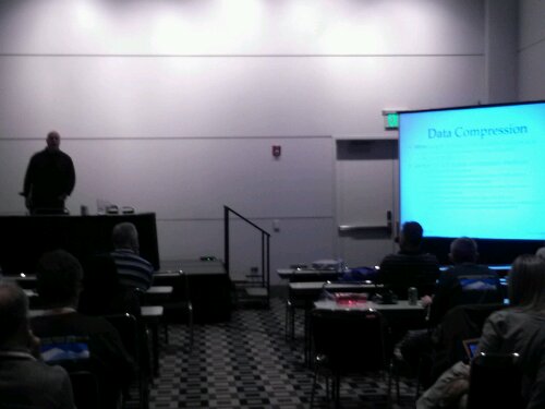 Tim Gorman (in the shadows) giving the last talk